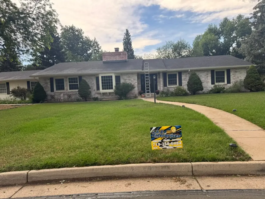 New roof on a brick ranch home with a J.R.B. yard sign
