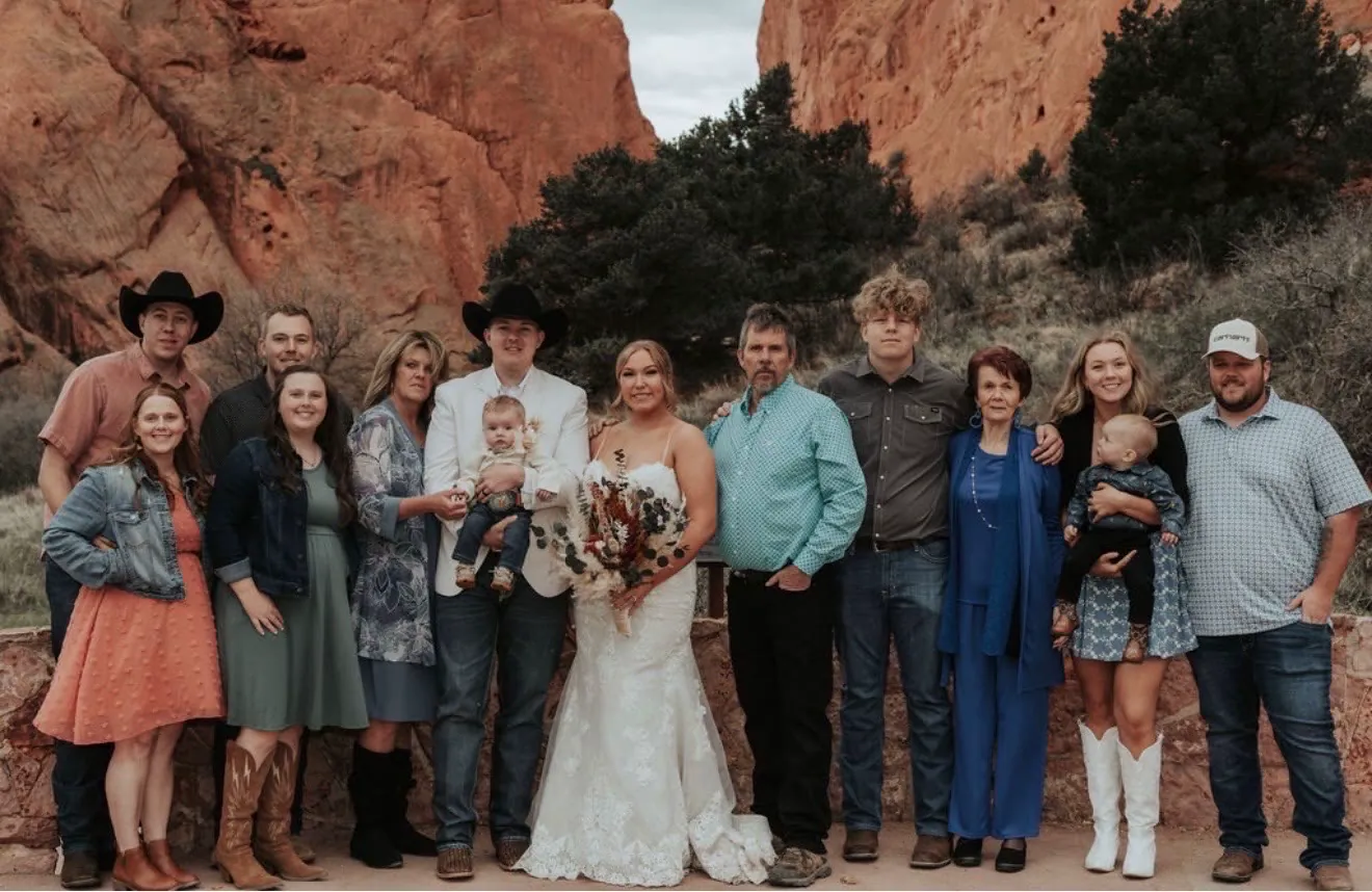 The whole Ullstrom family standing together in front of red rock cliffs